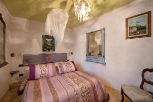 a bedroom with a bed and a chandelier at Casa Gocce Di Cristallo in Varazze