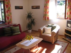 a living room with two couches and a coffee table at Ferienwohnung Blattmann in Sankt Peter