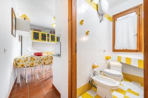 a bathroom with a toilet and a sink at Casa Leo in Calasetta +18 photos
