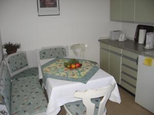 a kitchen with a table with a bowl of fruit on it at Ferienwohnung Blattmann in Sankt Peter