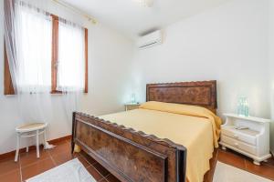 a bedroom with an old bed in a white room at Casa Leo in Calasetta