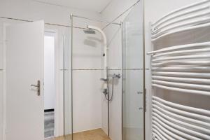 a shower with a glass door in a bathroom at Ferienwohnung Cakir in Meinerzhagen +23 photos