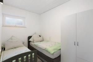 a bedroom with two beds and a window at Ferienwohnung Cakir in Meinerzhagen