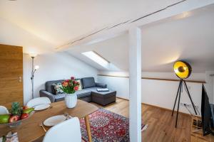 a living room with a couch and a table at Wohnung am See in Gmund am Tegernsee