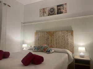a bedroom with a bed with two pillows on it at Buganvilla in Pájara