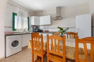 a kitchen with a table and chairs and a sink at Buganvilla in Pájara
