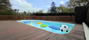 a pool with a soccer ball and toys in it at Madig Azul Maison Piscine Chauffée in La Trinité-sur-Mer
