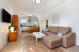 a living room with a couch and a table at Buganvilla in Pájara