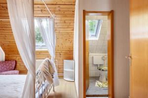 a small bedroom with a bed and a bathroom at Haus Antonis in Triberg +70 photos