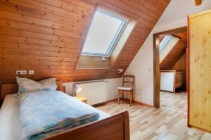 a bedroom with a bed and a large window at Ferienwohnung Saupp in Immenstaad am Bodensee