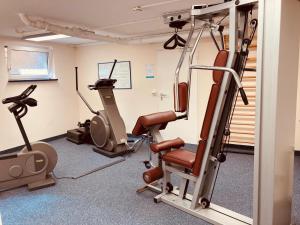 a gym with treadmills and machines in a room at 109 im Lord Nelson in Cuxhaven
