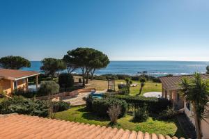 a house with a view of a garden and the ocean at Le Gemelle al 212 in Villaputzu