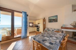 a dining room with a table and a view of the ocean at Le Gemelle al 212 in Villaputzu