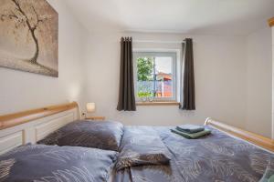 a bedroom with a bed and a window at Ferienhaus Frieda in Röfingen
