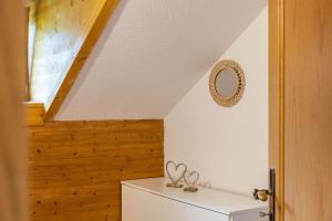 a bathroom with a toilet and a wooden wall at Ferienwohnung Reschberg in Farchant +15 photos