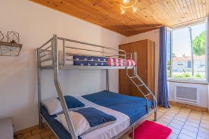 a bunk bed in a room with a window at La Desirade in Saint-Agnant +15 photos