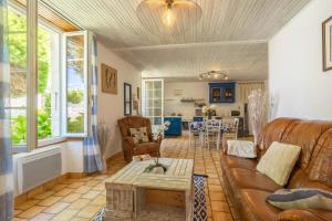 a living room with a couch and a table at La Desirade in Saint-Agnant