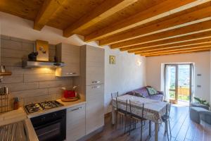 a kitchen with a table and a kitchen with a dining room at Artù in Tremosine Sul Garda +17 photos