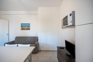 a living room with a couch and a table at Appartamento Andromeda B4 in Bibione