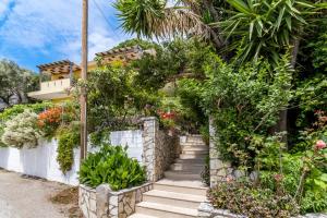 a staircase leading to a house with flowers and plants at Villa Captain Fotis 3 in Póndi +20 photos