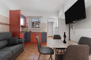 a living room with a couch and a table at One life one dream Gran Canaria in Carrizal