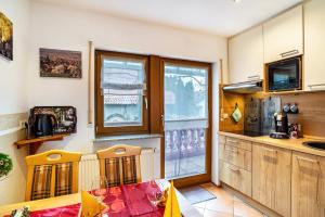 a kitchen with a table and two chairs in a room at Burgblick in Lauf