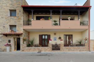 a brick building with balconies and plants on it at Casa Zoraide in Borgagne