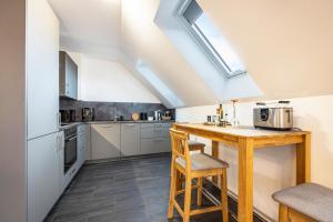 a kitchen with a wooden table in a room at Ferienwohnung Lampa in Wasbüttel