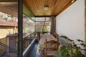 a room with a table and chairs on a balcony at Casa Merlino in Biassa