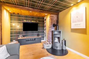 a living room with a fireplace and a television at Ferienhaus Altstadtchalet in Schmallenberg