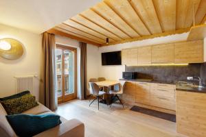 a living room with a kitchen and a table at Kriendl Nr 1 in Valdaora
