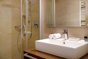 a bathroom with a sink and a shower at Kriendl Nr 1 in Valdaora +16 photos