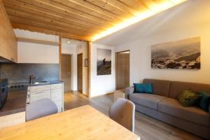 a living room with a couch and a table at Kriendl Nr 1 in Valdaora
