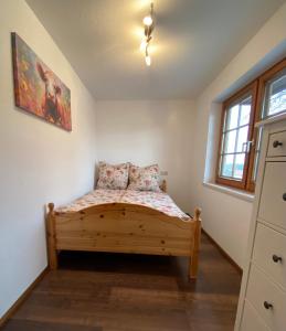 a bedroom with a bed in the corner of a room at Schwarzwaldnest Dachsberg in Wilfingen