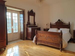 a bedroom with a bed and a dresser and a mirror at Casa do Terreiro in Barqueiros +14 photos