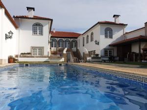 a swimming pool in front of a house at Casa do Terreiro in Barqueiros