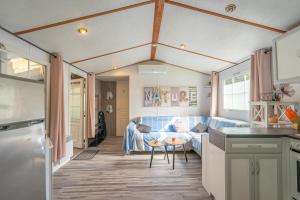 a kitchen and a living room with a couch at Mh 229 La Tremblade in La Tremblade