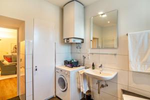 a bathroom with a washing machine and a sink at Merkurblick in Baden-Baden +24 photos