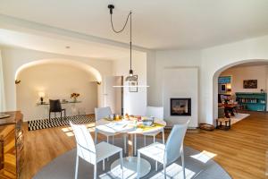 a dining room and living room with a table and chairs at Merkurblick in Baden-Baden