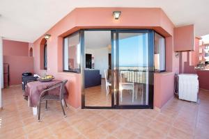 a living room with a table and a dining room at Vista de Lobos in Corralejo