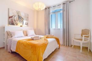 a bedroom with a bed with a yellow blanket on it at Vista de Lobos in Corralejo