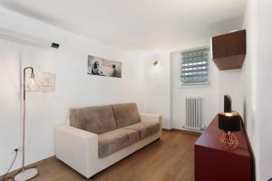 a living room with a couch and a table at Suite Strada Persa in Pavia
