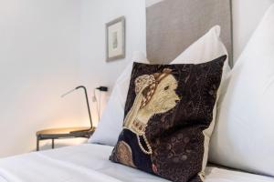 a pillow with a picture of a camel on a bed at Casa Maria in Porto Ceresio