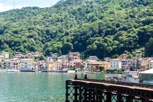 a town on the water next to a mountain at Casa Maria in Porto Ceresio