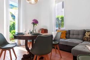 a living room with a table and a couch at Casa Maria in Porto Ceresio