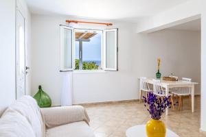 a living room with a couch and a table at Anemologio 301 Tinos in Agios Ioannis