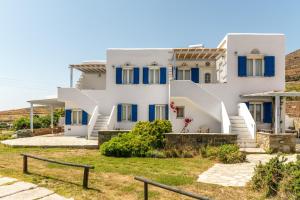 a white house with blue shutters and stairs at Anemologio 301 Tinos in Agios Ioannis +17 photos