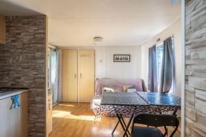 a living room with a table and a couch at Mh310 La Tremblade in La Tremblade