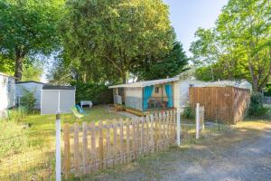 a tiny house in a yard with a fence at Mh310 La Tremblade in La Tremblade +12 photos