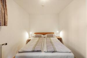 a bed with two pillows on it in a room at Zwei-Zimmer-Wohnung in Schopfheim in Schopfheim